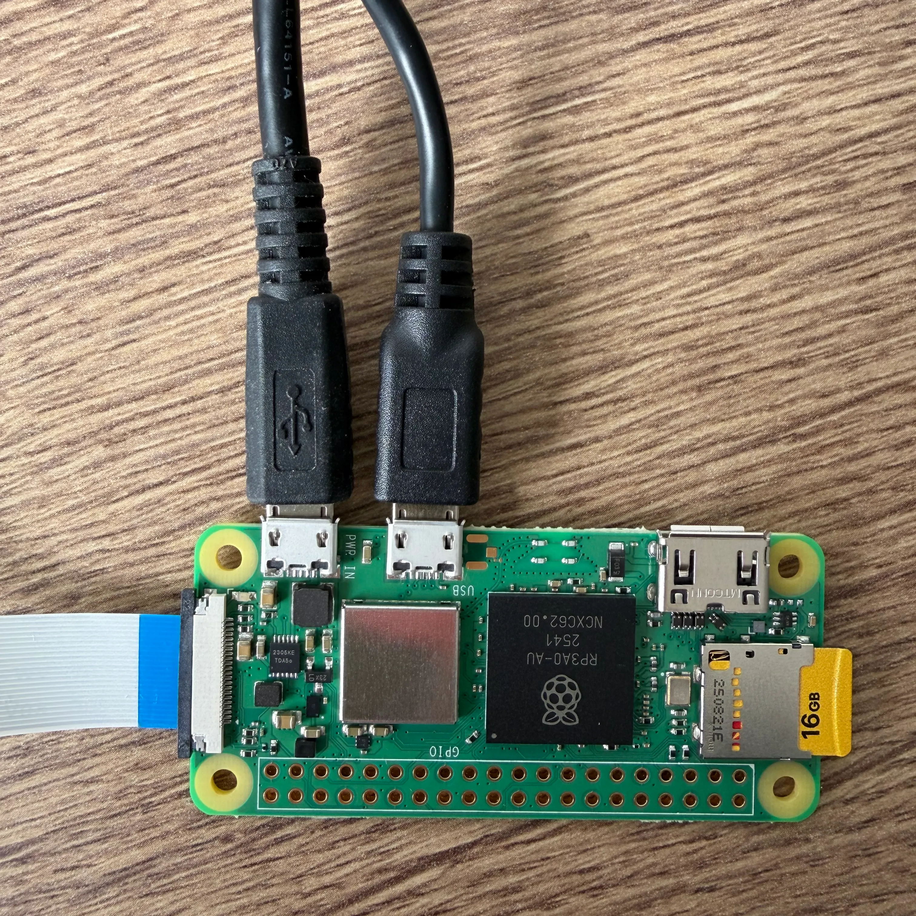 Photo of the setup showing the CSI connection and the two cables connected to the Raspberry Pi's micro-USB ports